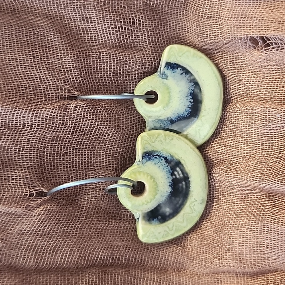 Artisan created earrings on blue titanium ear wire.